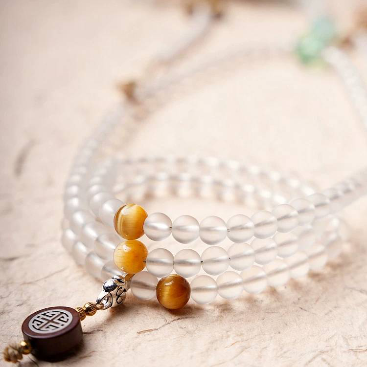Handmade white glass bead necklace with 108 beads, suitable for meditation and spiritual practice. Women's bracelet featuring White Tara.